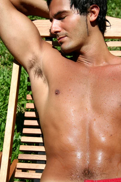 Shirtless young man tanning