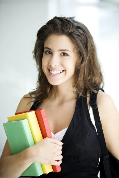 Smiling girl holding books