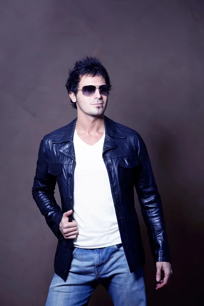 Man in leather jacket posing