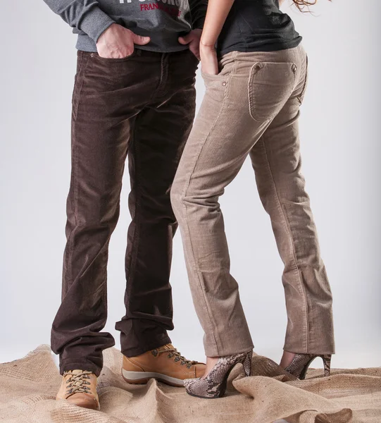 A man and a woman in corduroy pants