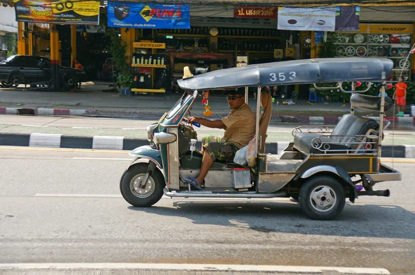 Unidentified taxi driver with traditional tuk-tuk in Chiangmai , Thailand.
