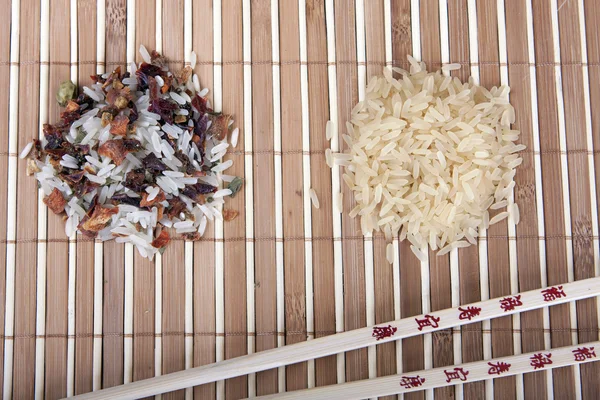 Two slides rice and Chinese sticks on the Mat
