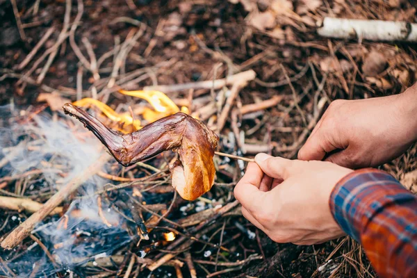 Rabbit on the stick grilled in the fire. delicious summer picnic