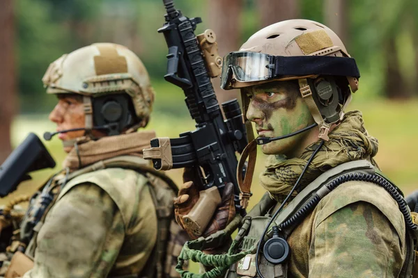 Soldier stands with arms and looks forward