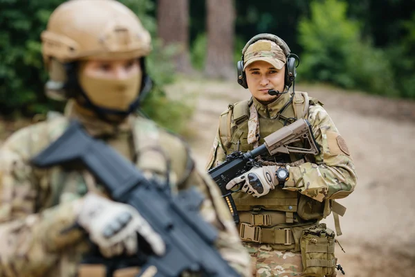 Two soldiers scout the area occupied by the enemy