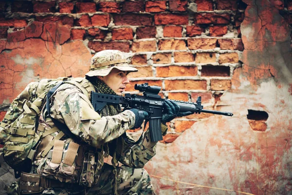 Soldier with rifle in the forest