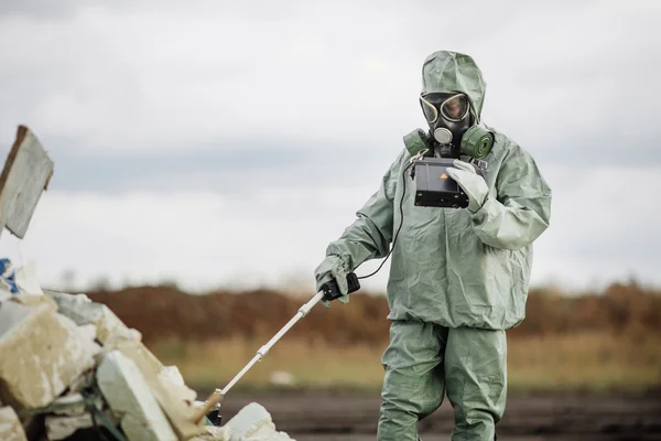 Scientist (radiation supervisor) in protective clothing and gas