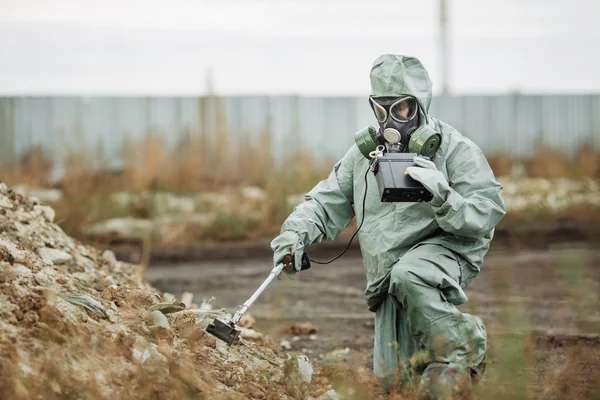 Scientist (radiation supervisor) in protective clothing and gas