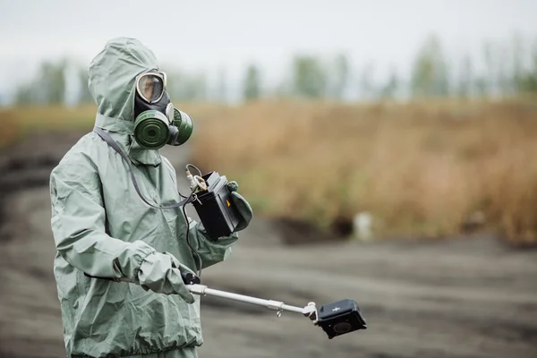 Scientist (radiation supervisor) in protective clothing and gas