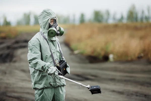 Scientist (radiation supervisor) in protective clothing and gas