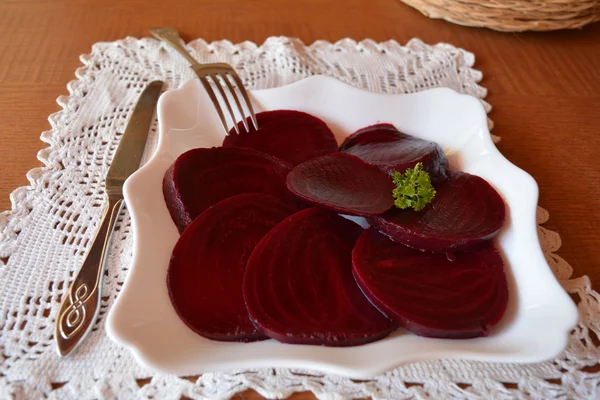 Fresh sliced organic beet root on a white plate