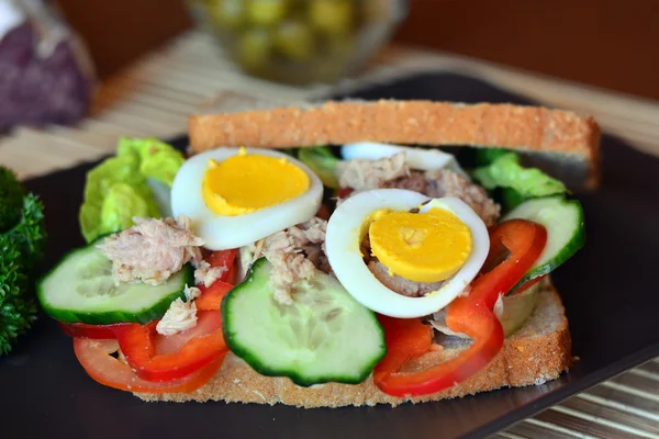 Rye bread sandwich with tuna fish, eggs, tomato and cucumber
