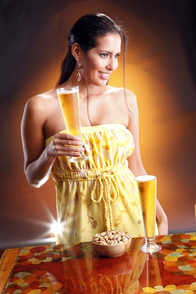 Cute brunette girl with beer and nuts