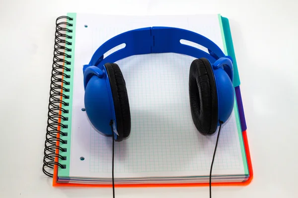 Headphones lying on a notebook