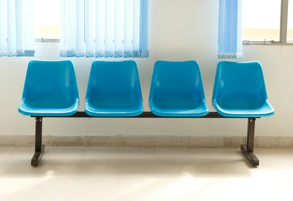 Blue empty chairs on waiting room.
