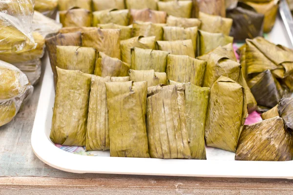 Thai traditional sticky rice dessert in banana leaf packaging.Kh