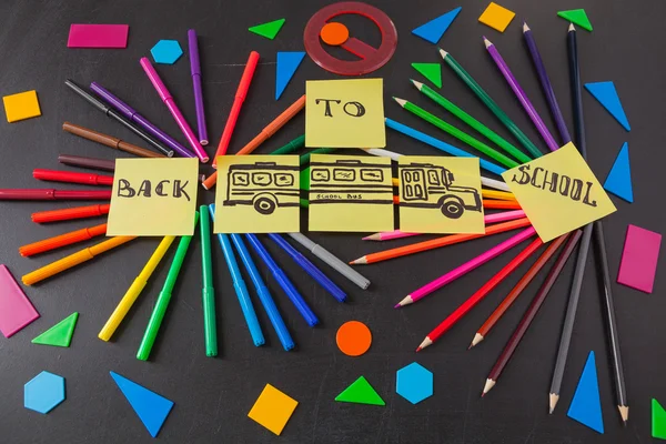 Back to school background with a lot of colorful felt-tip pens and colorful pencils in circles, titles 