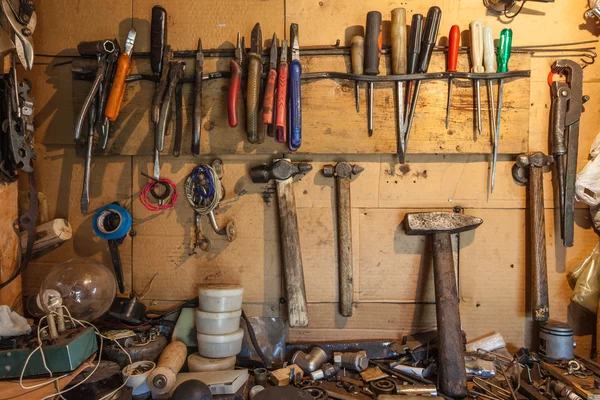 Tools on the wall and table to keep hammers, wrenches, ring spanners, hammer, pliers, screwdrivers, monkey wrenches, screws, bolts, adjustable wrench