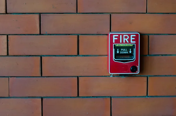 Fire alarm on brick wall