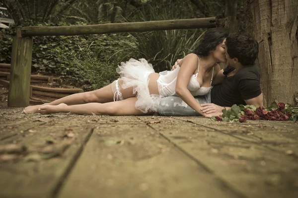 Young beautiful couple enjoying a romantic time together in woods