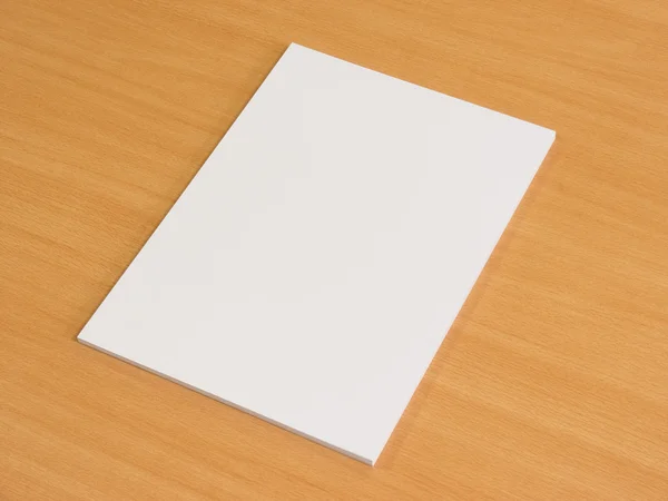 Blank papers on wooden office table.