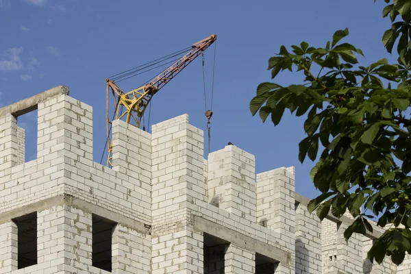 White brick walls of New building on a background of blue sky