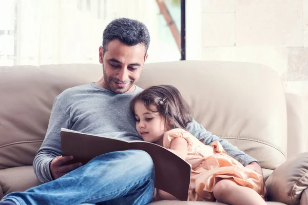 Little Girl And Father Reading Book Together