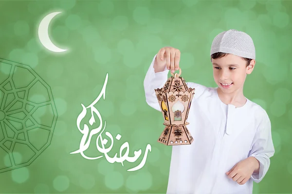 Ramadan Kareem - Happy young kid playing with Ramadan lantern
