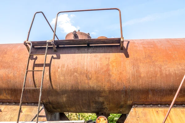 Old rusty, tank wagon, top detail with bridge, handles and valve