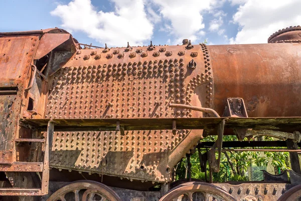 Old Czechoslovakian CSD steam engine on graveyard, rusty, boiler with fireplace detail