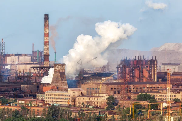 Steel factory with smokestacks at sunset. metallurgical plant. steelworks, iron works. Heavy industry in Europe. Air pollution from smokestacks, ecology problems. Industrial landscape