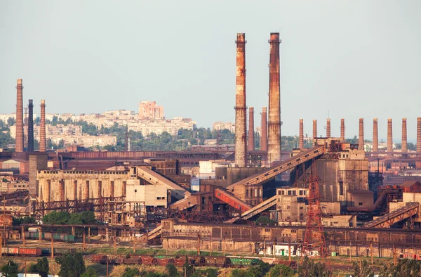 Steel factory with smokestacks at sunset. metallurgical plant. steelworks, iron works. Heavy industry in Europe. Air pollution from smokestacks, ecology problems. Industrial landscape