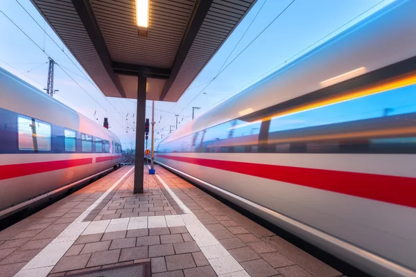 High speed passenger trains on railroad platform in motion