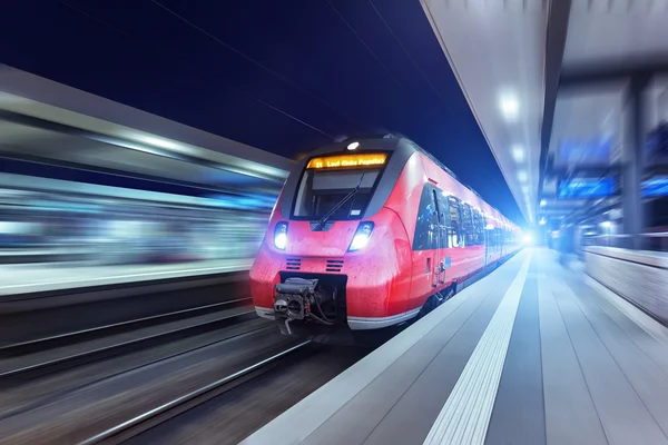 Modern high speed red passenger train at night