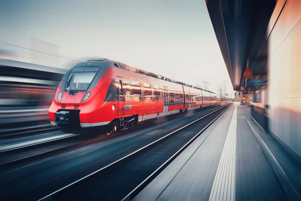 Beautiful railway station with modern red commuter train in moti