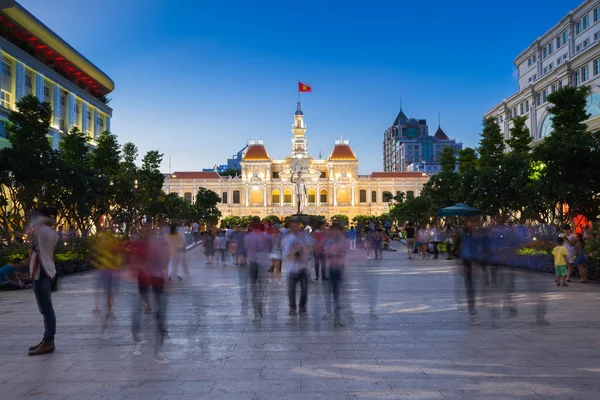 People are walking and taking pictures in front of the City Hall building, Ho Chi Minh City