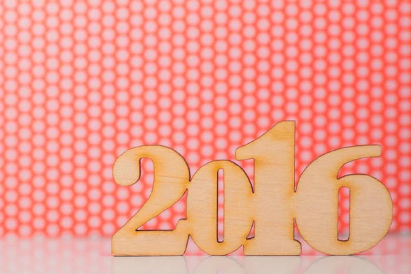 Wooden inscription of 2016 year on red and white background
