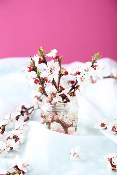 Branches with flowers in glass bottle