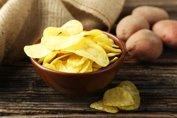 Chips in bowl and potatoes