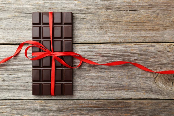 Dark chocolate bar with red bow