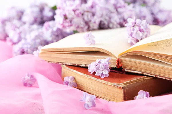 Beautiful lilac flowers with books
