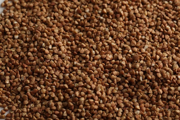Pile of buckwheat seeds background