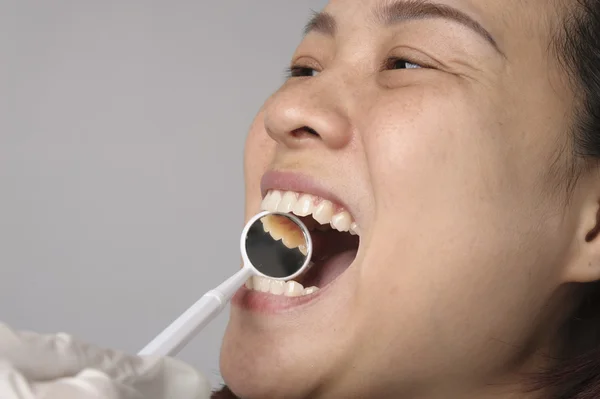 Woman has checking toot and mouth