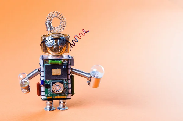 Robot concept retro style. Circuits socket chip toy mechanism, funny head, eyes glasses, light bulbs in hands. Copy space, orange gradient background