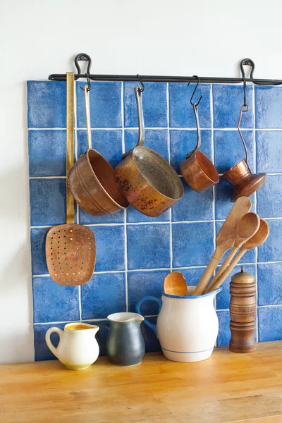 Kitchen accessories. pots jug pan wooden spoons, cooper ladle stewpan. wood table background