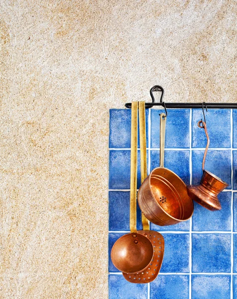 Kitchen interior with kitchen accessories. Hanging retro design copper kitchenware set.