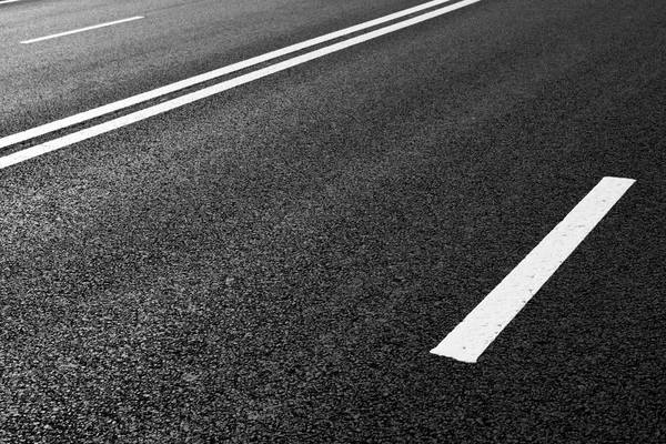 Asphalt road with marking lines white stripes