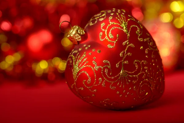 Christmas ball heart red and gold on blurred background