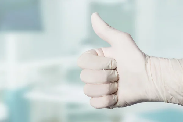 Doctors hand shows thumb up
