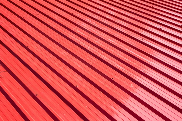 Red metal sheet for industrial building and construction.